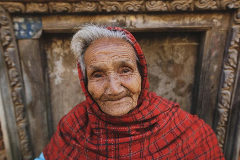 a woman in a red scarf poses for a picture