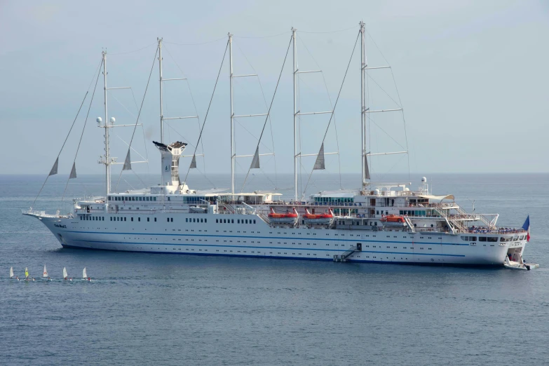 a ship sailing in the ocean next to an anchor