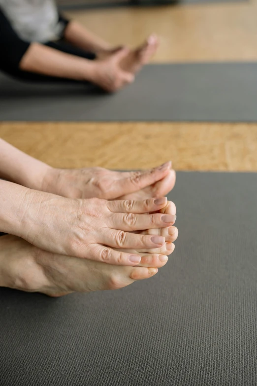 the legs of people are stretching in a yoga position