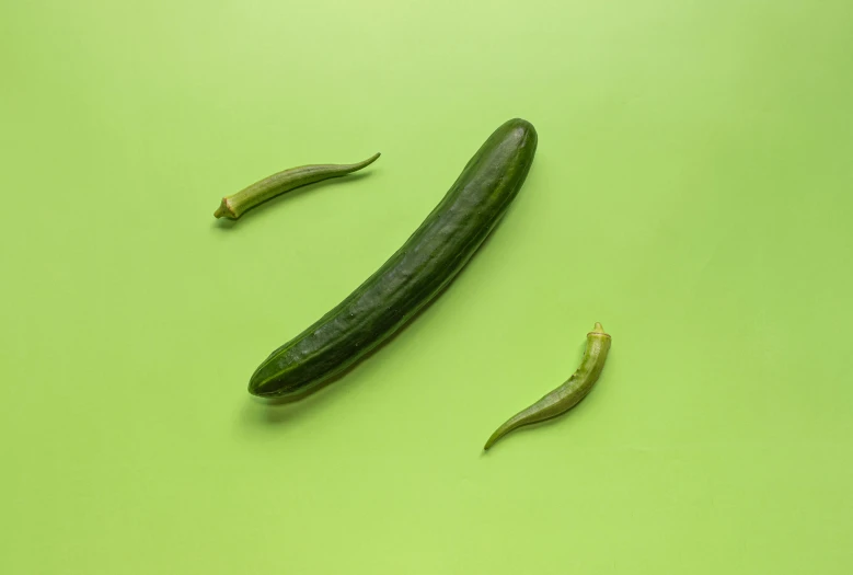 a few green pickles sitting on a table