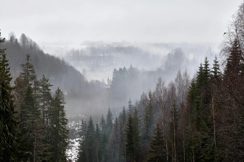 a mountain range with fog coming down the side