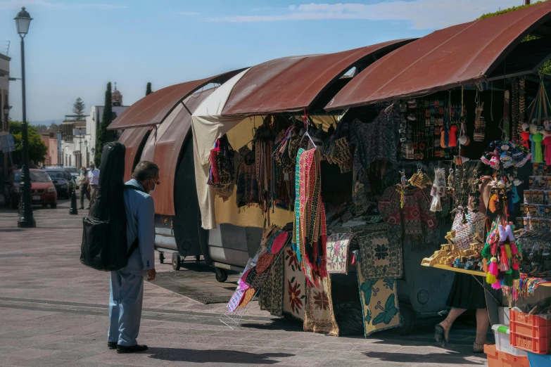 a man standing next to a train car with many items in it