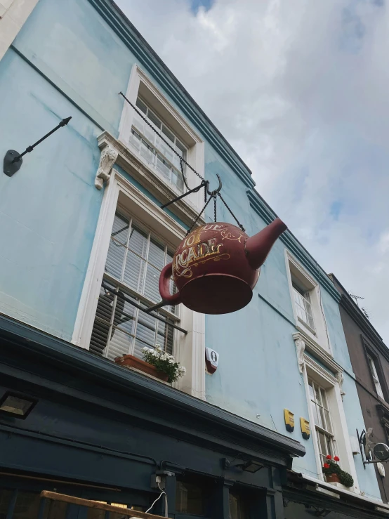 a large metal vase hanging from a building