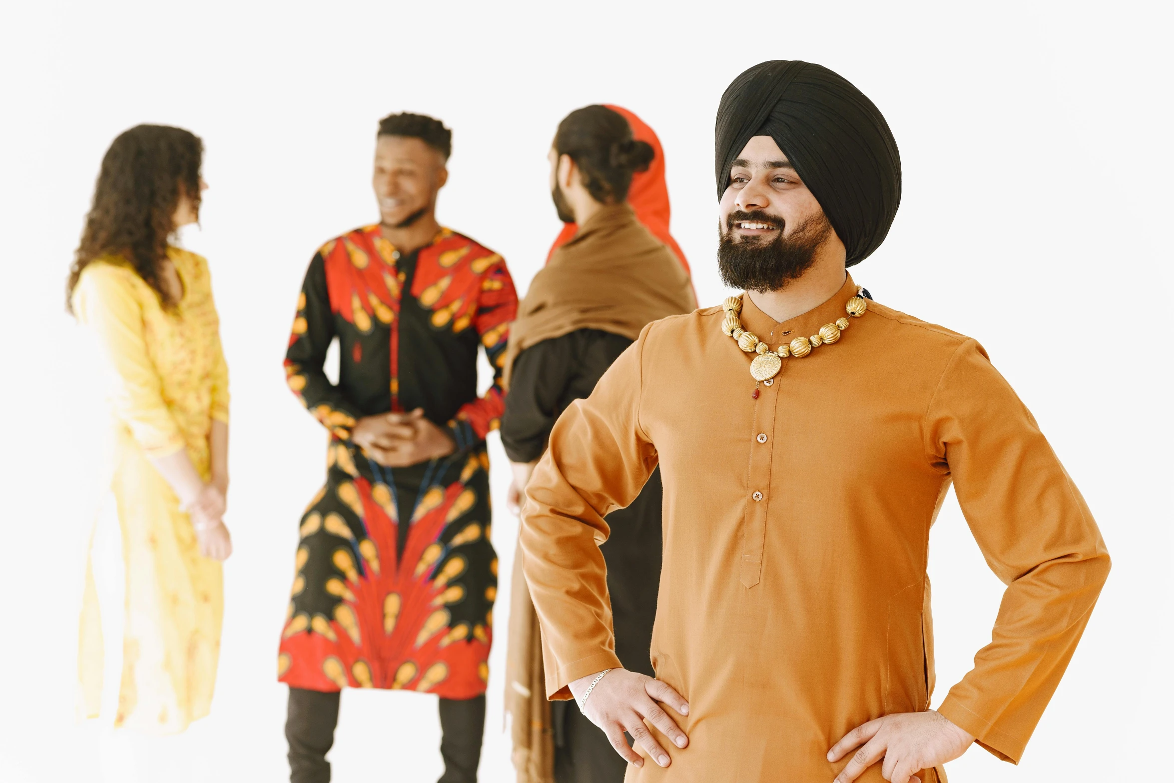 man in an orange turban, and others wearing dress clothes