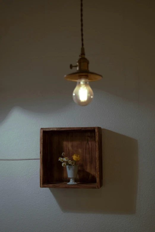 a lamp that is on a white wall