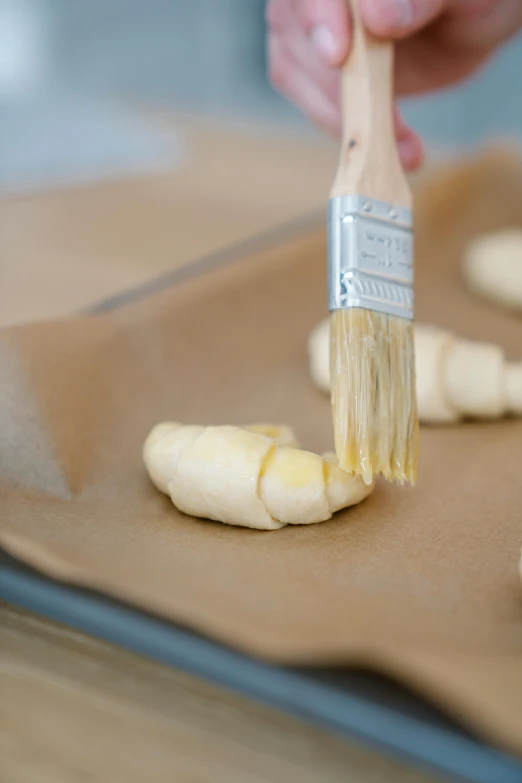 a paintbrush is being used to apply some er onto bread