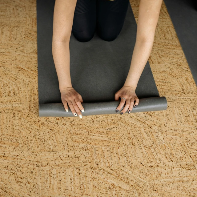 woman doing yoga poses on a mat on the floor