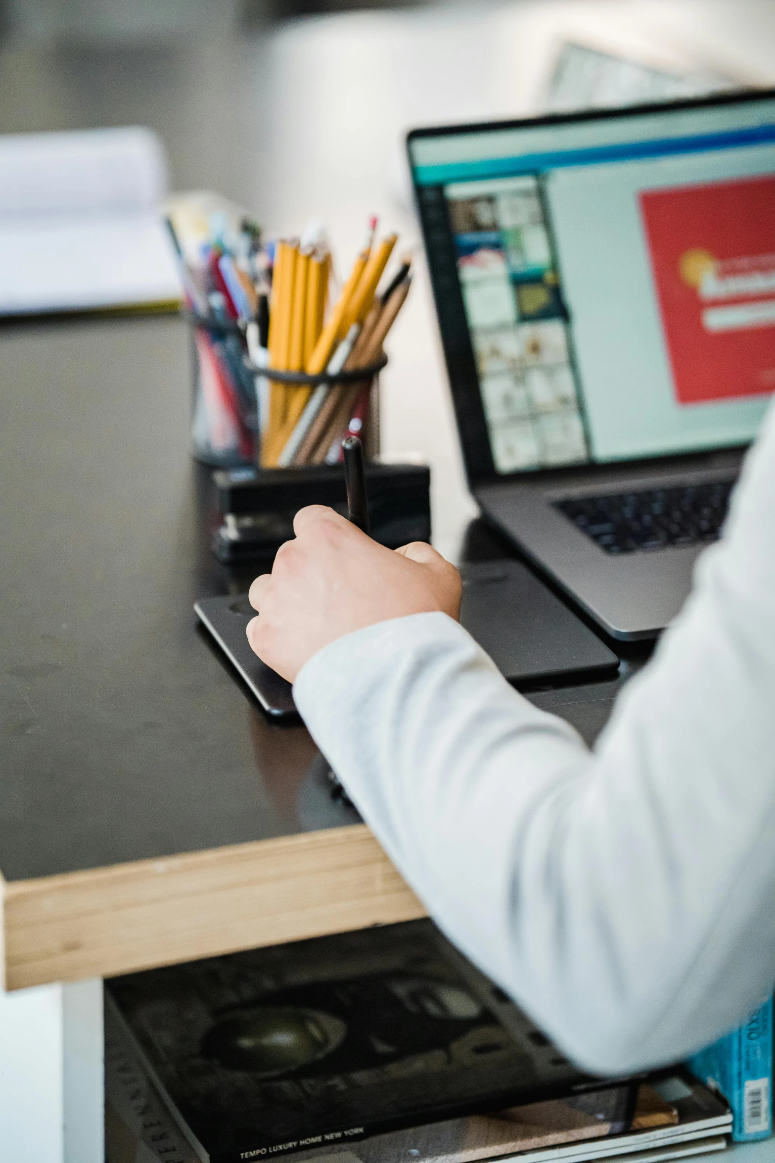 man on a desk using laptop computer and mobile phone