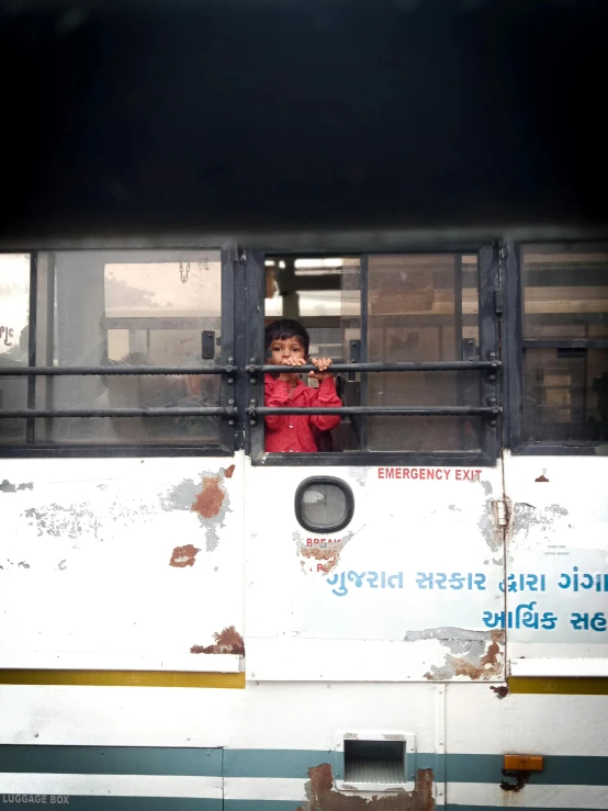  sitting on top of an old bus looking over it