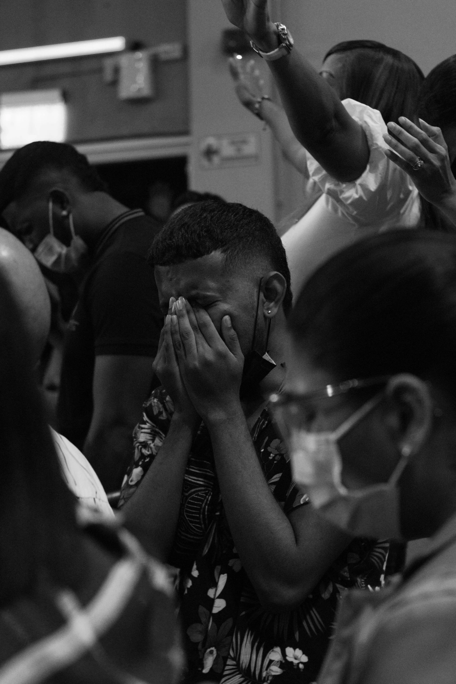 a group of people wearing protective glasses hold up their hands