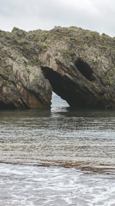 large rocks on the shoreline on a cloudy day