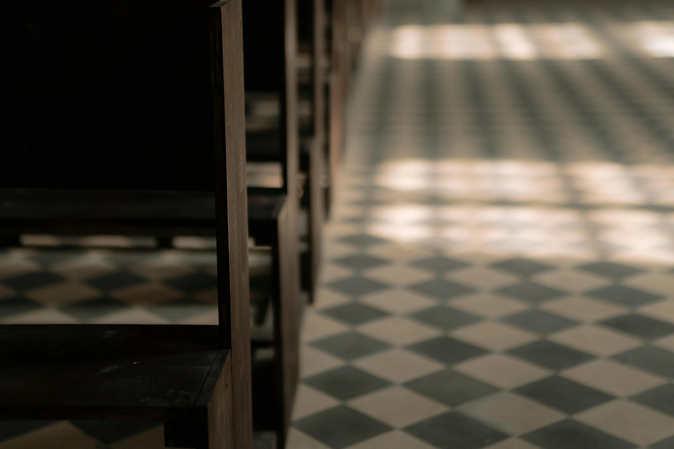 a room filled with wooden furniture and a checkered floor