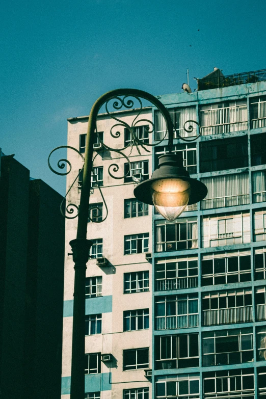 the lamp post has been erected against a large building