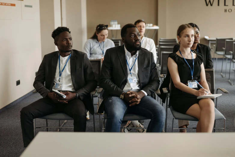 several people sitting in chairs at a convention