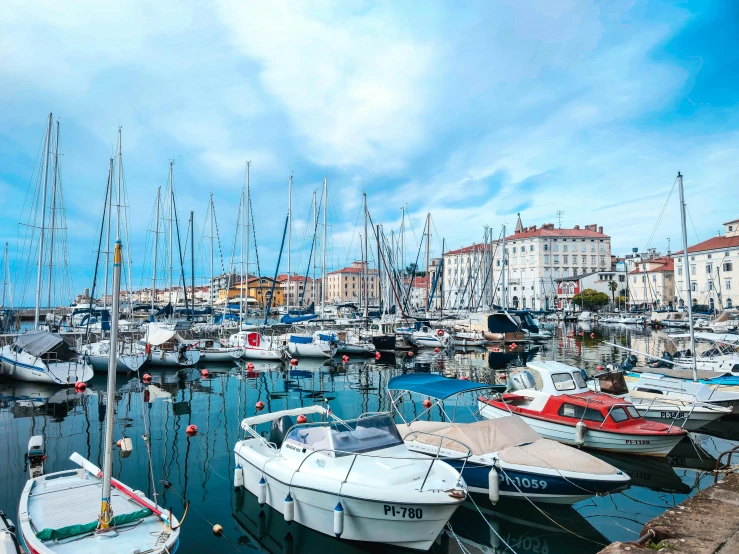 a marina filled with lots of boats next to tall buildings