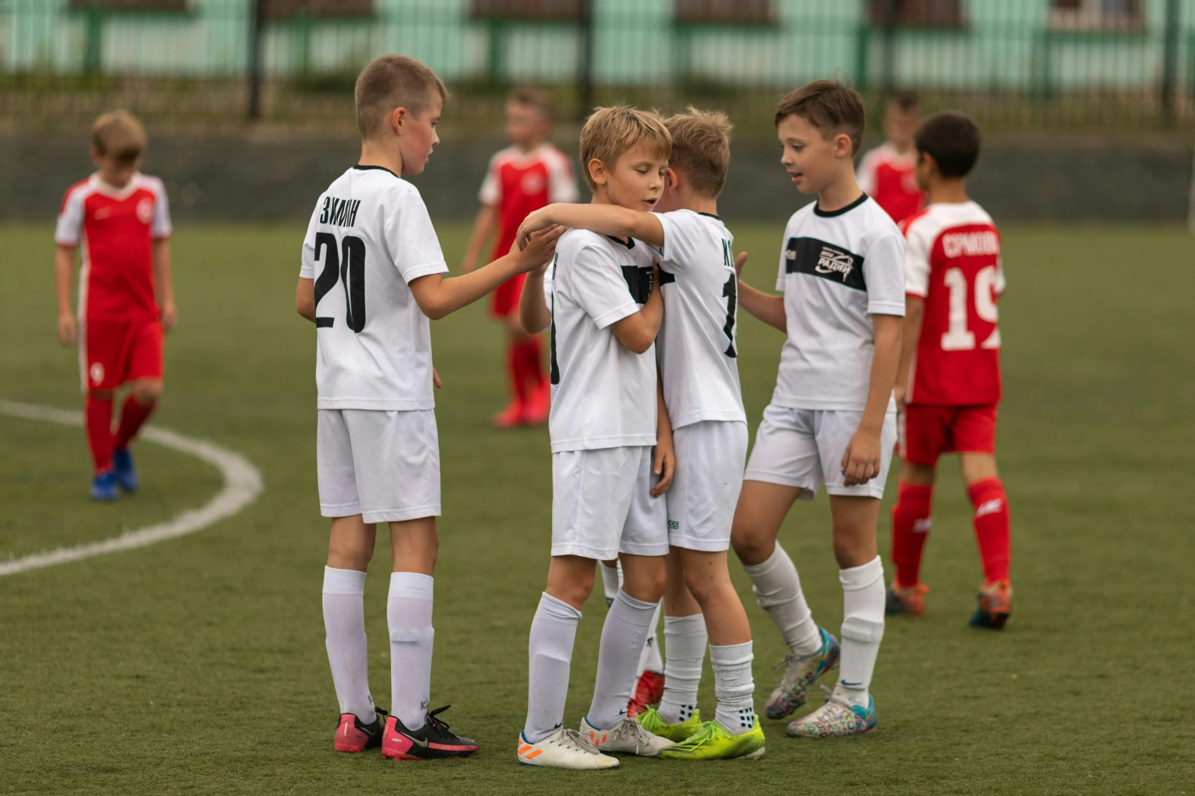 a group of s huddle together in a soccer match