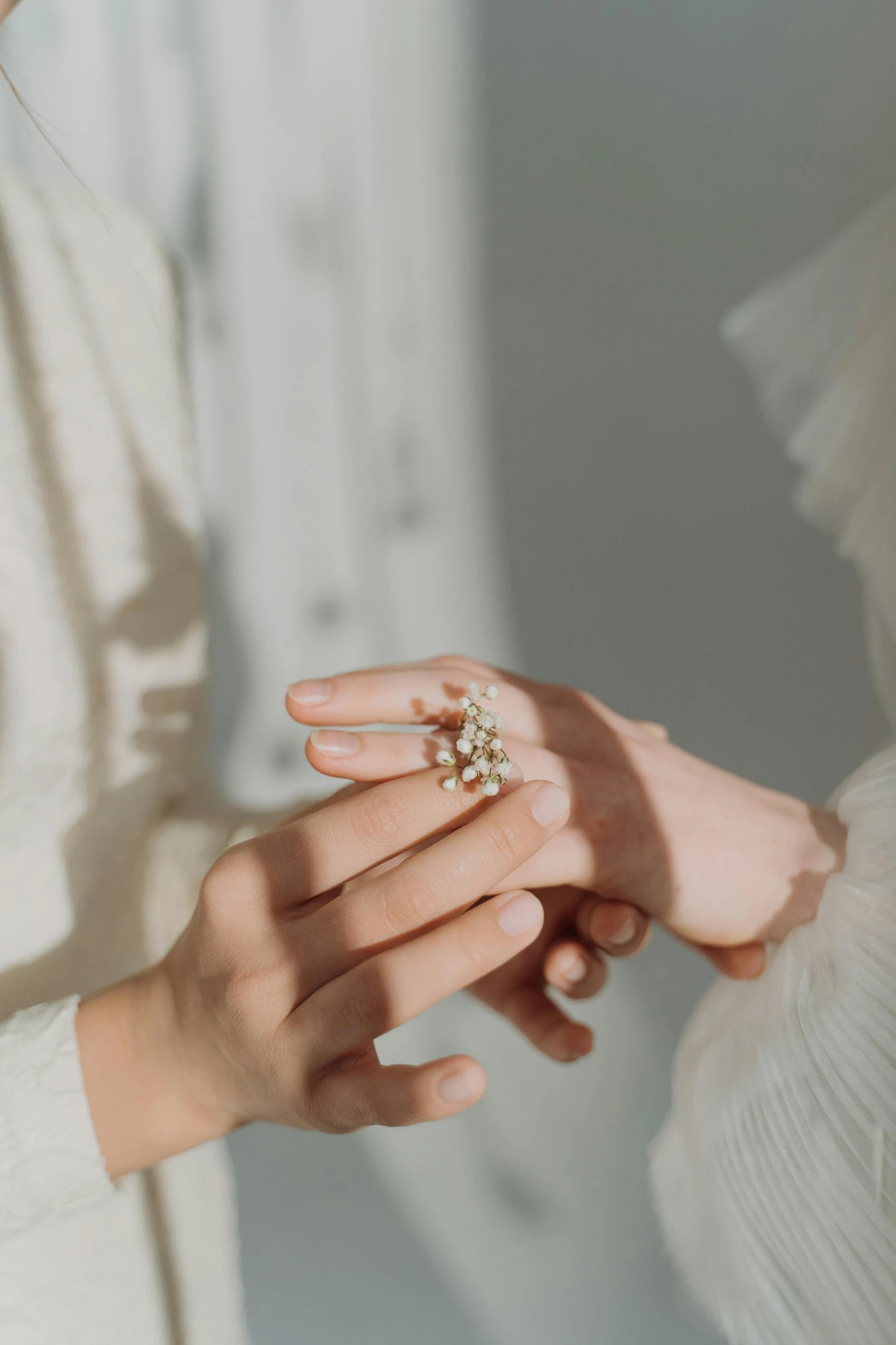 a woman in white holding her hands out to the camera