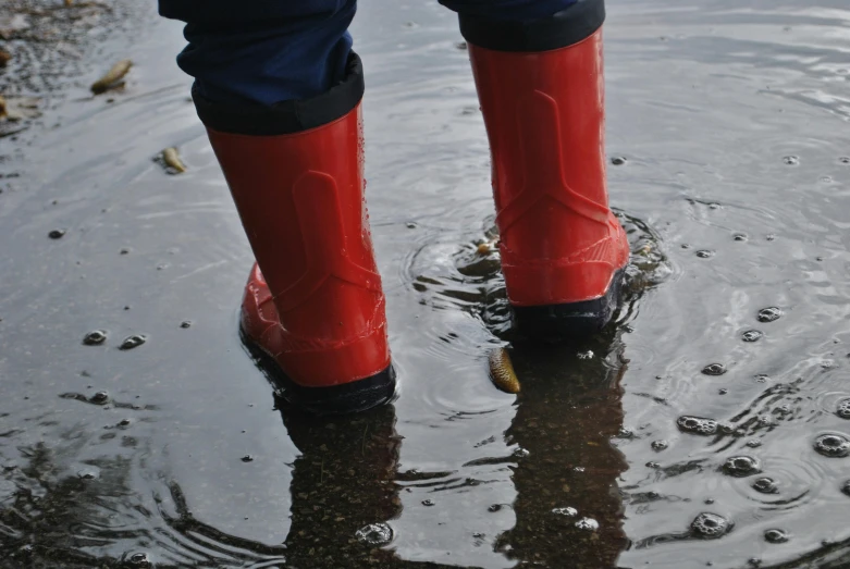 a person in red boots stands on a dle