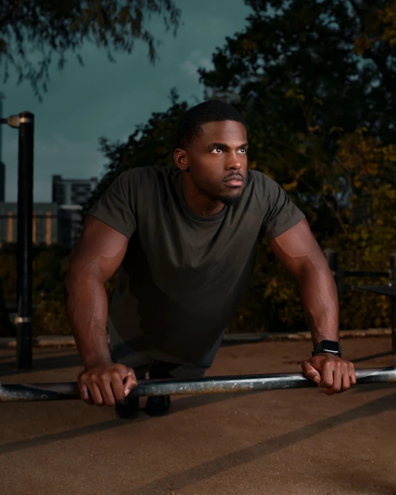 a black man is leaning on a pole