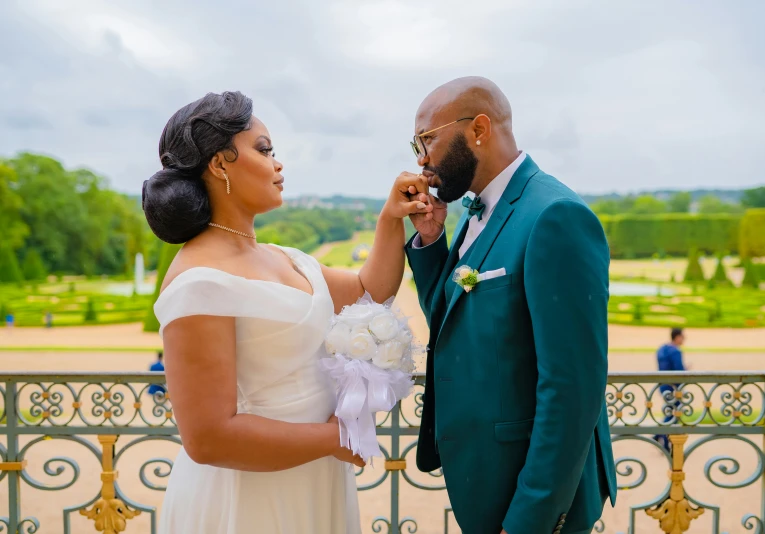 a bride holds up the flower for the groom