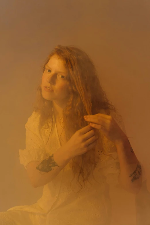 a woman brushing her hair with yellow dust