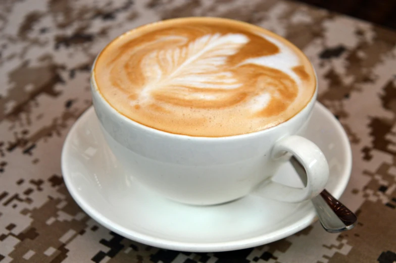 a latte is on a plate and on a military table