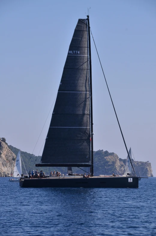 a sailboat floating along a large body of water