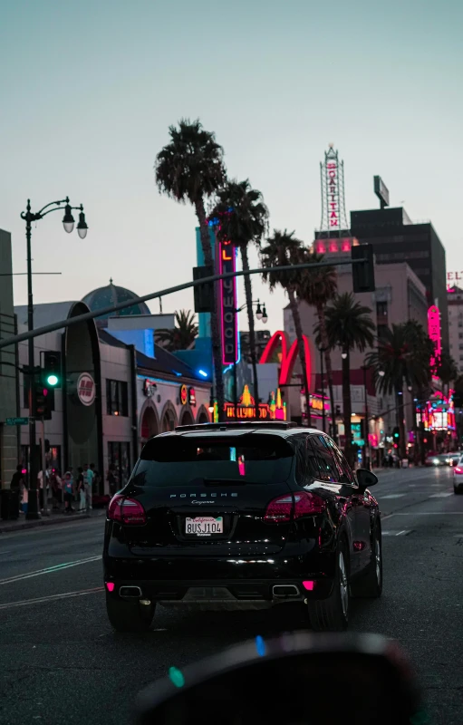 a car driving through the city at dusk