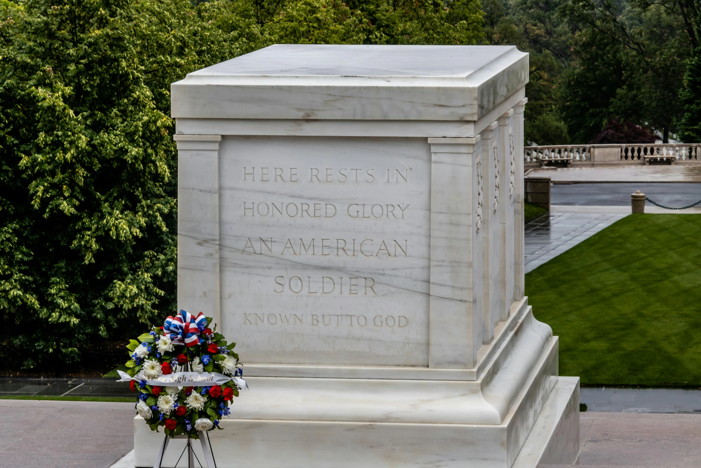 a wreath lies at the base of the war memorial