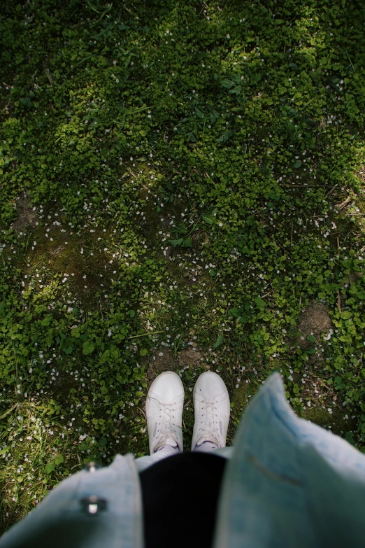 an aerial view of someones feet in the green grass