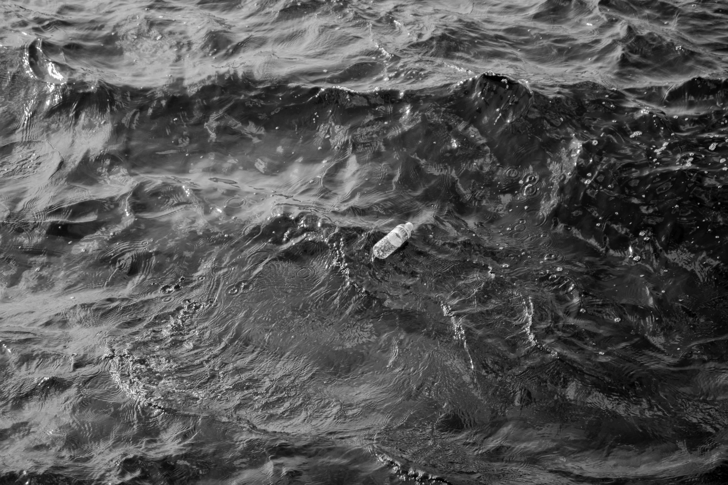 black and white pograph of water with dark clouds