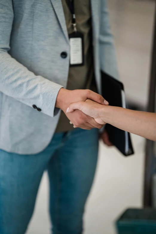 two people shake hands during a business conference