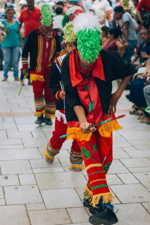 some people in colorful costume walking down the street