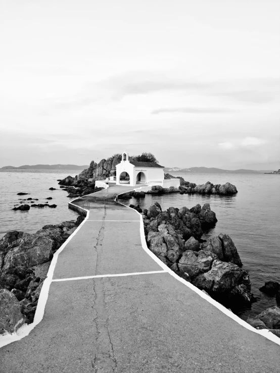 the white building is on an island near the ocean