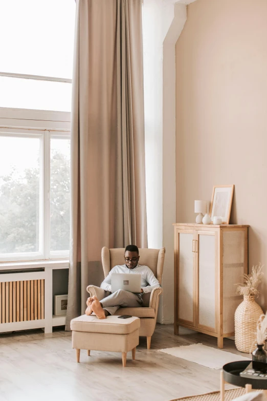 a man that is sitting down with his feet on the couch