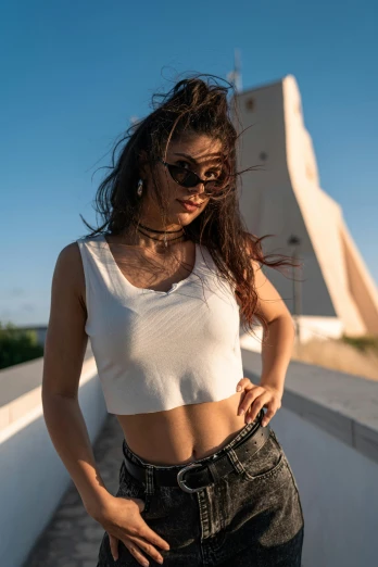 the woman is posing for a picture wearing a crop top