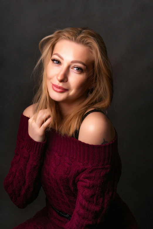 a woman with blonde hair posing for the camera