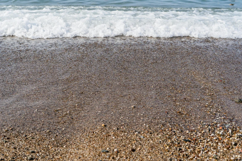 the small waves lap the beach near the shore