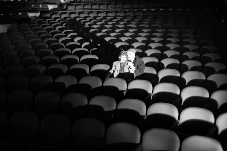 an empty auditorium with a row of chairs