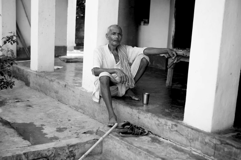 a woman sitting on steps in front of a building