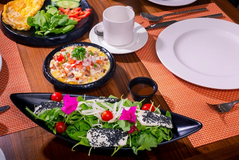 a table that has plates and bowls with food on it