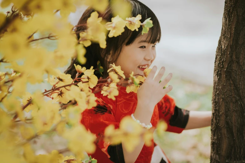 a beautiful young lady leaning against a tree