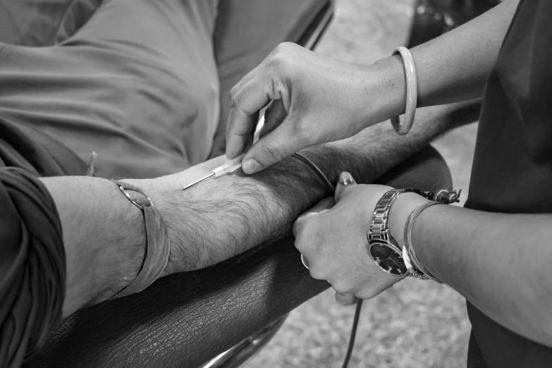 black and white pograph of a person  another persons arm