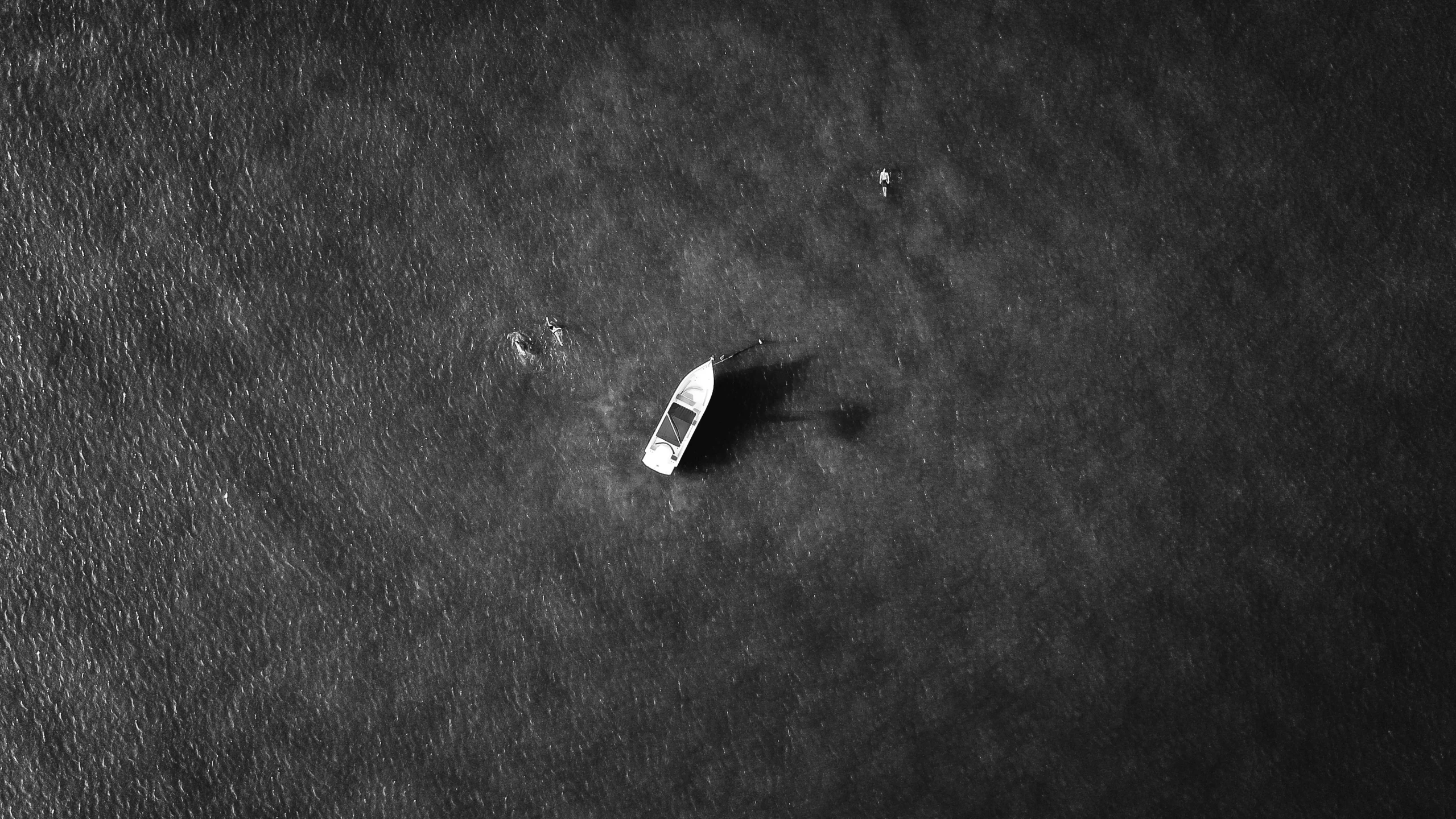 a rock in the sand and two footprints on the sand