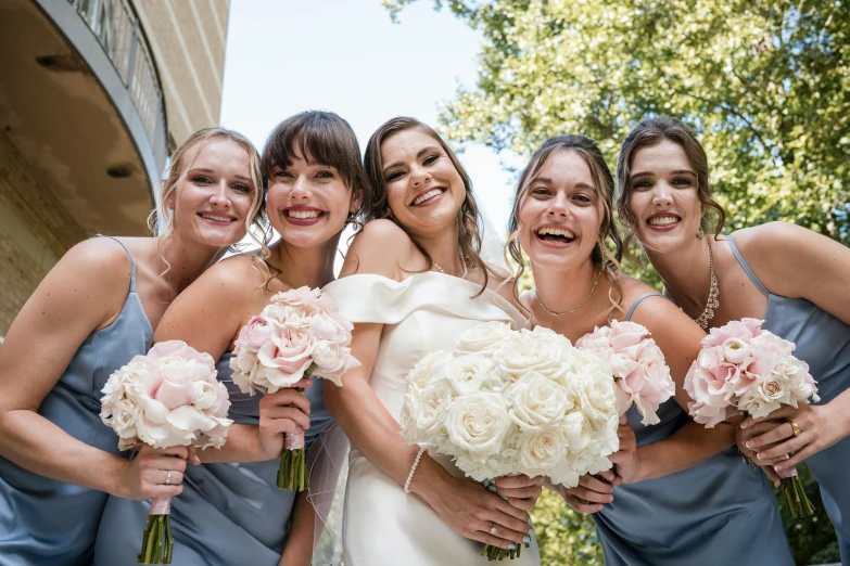 wedding party of bride and her bridesmaids all posing for a picture