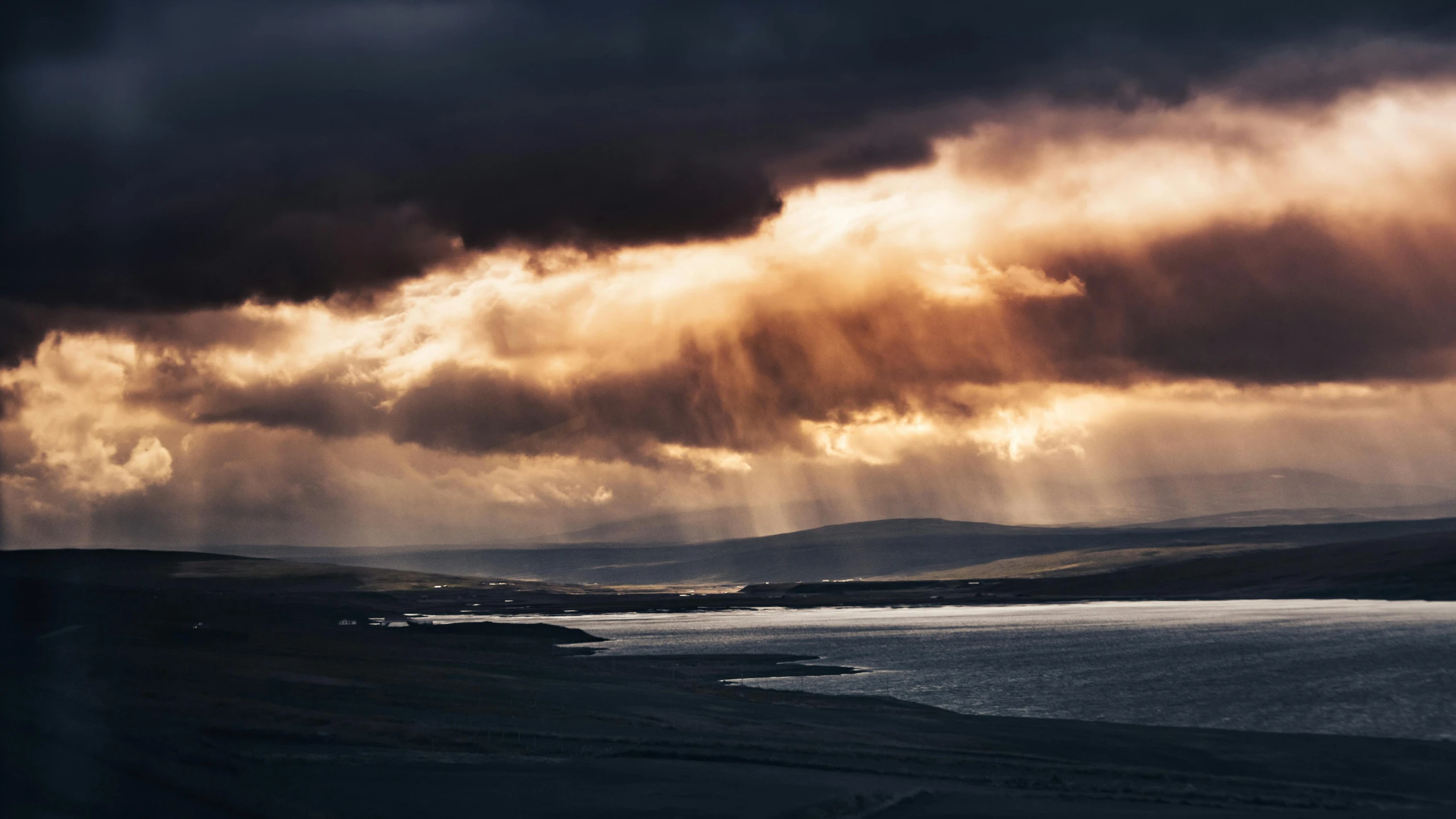 clouds over a body of water under the sun