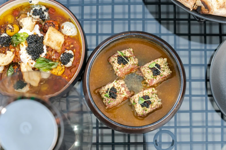 three bowls of food sitting on top of a counter