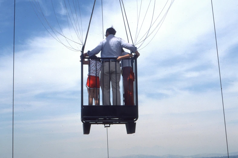 two people riding the gondola on a mountain top