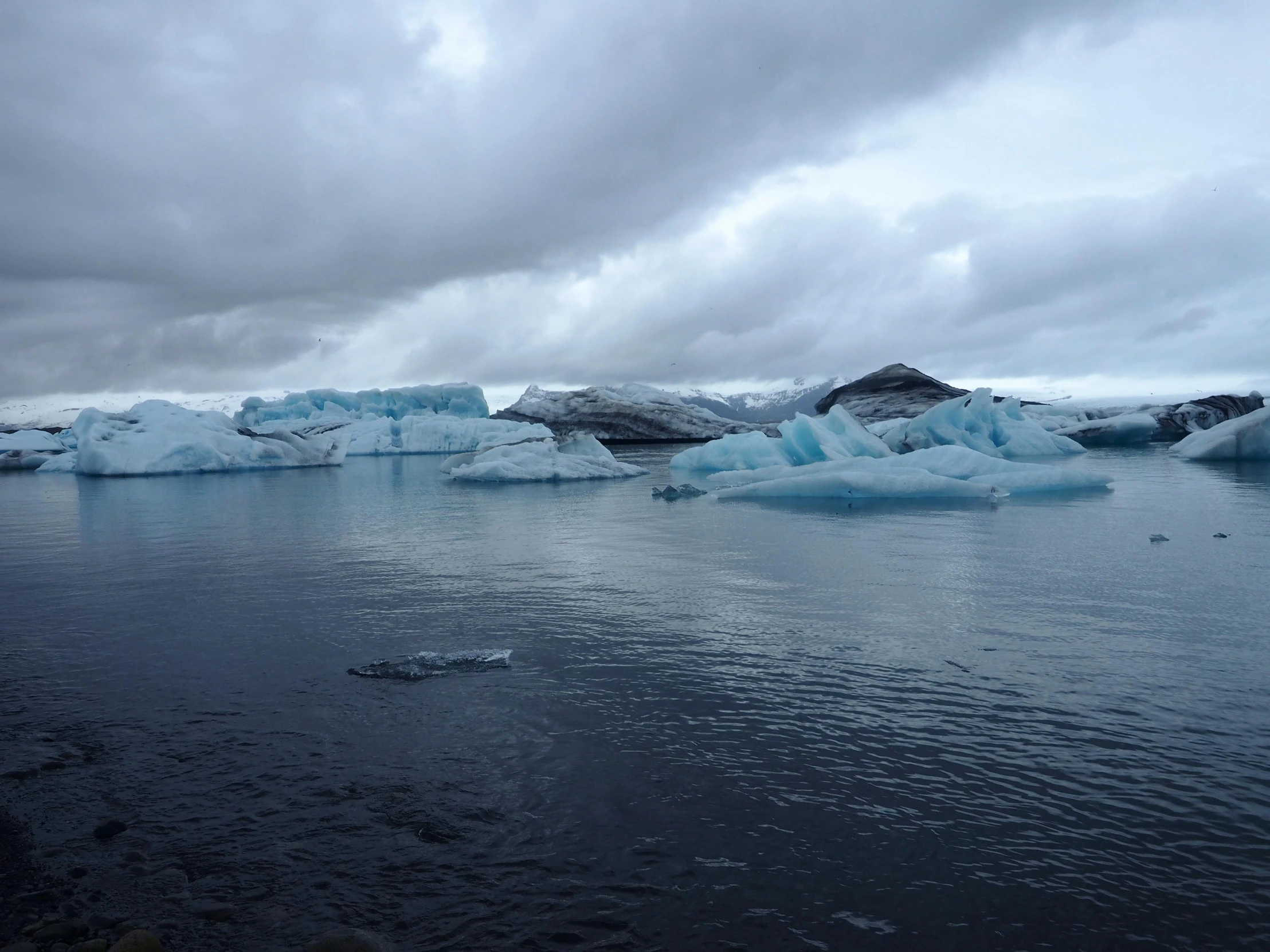 a large glacier floating on top of water near the ocean