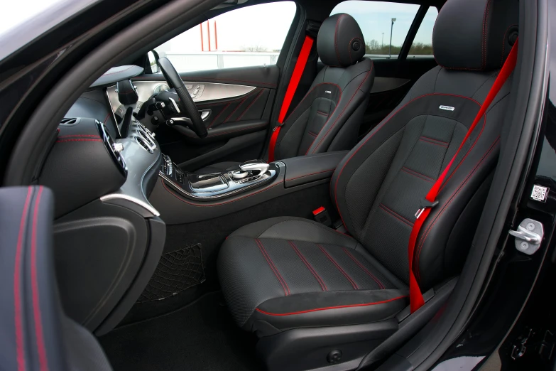 an image of inside of a car that is black and red